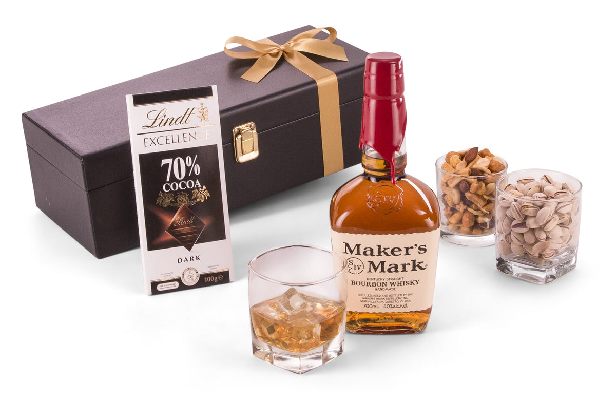 Open bottle of Makers Mark bourbon whiskey with red wax seal and clear glass, showcasing the rich amber liquid inside.