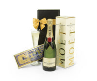 Open bottle of Moet Chandon champagne with a gold foil label, placed on a festive table setting.