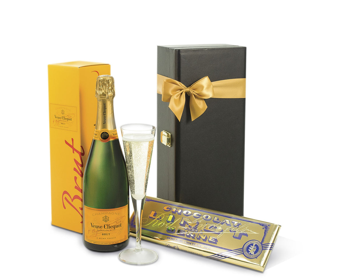 Open bottle of Veuve Clicquot champagne in a decorative gift box, showcasing the elegant yellow label and branding.
