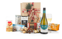 Open box of Interhampers Merry Christmas White holiday gift packaging with festive white design and ribbon.