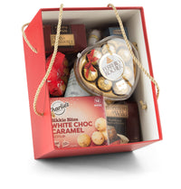 Assorted Sweet Christmas treats in festive packaging by Interhampers, ready for holiday gift giving.