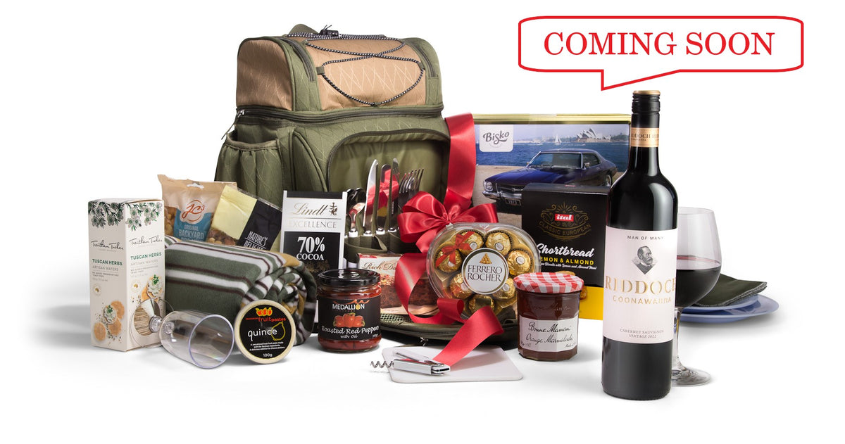 Open picnic basket from Interhampers Picnic On The Go set showing plates, utensils, and food compartments inside.