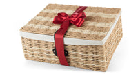 Closed view of a regal red Interhampers gift basket with elegant packaging and ribbon, perfect for special occasions.