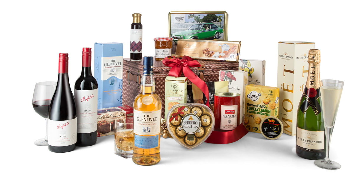 Open box of Interhampers Indulgence gourmet gift basket with chocolates and treats, showcasing luxurious packaging and contents.