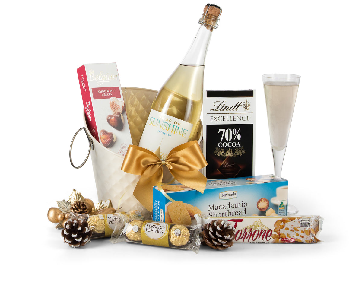Open gift box with colorful decorations and a "Let's Celebrate" banner, from Interhampers, perfect for festive occasions.