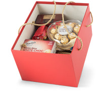 Festive Christmas in a Box gift set by Interhampers with wrapped holiday treats and decorations inside a box.