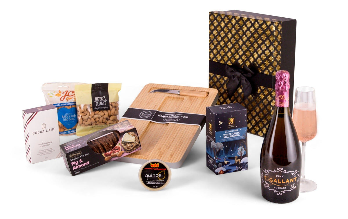 black and gold gift box with pink sparkling Moscato, bamboo cheese board, and snacks