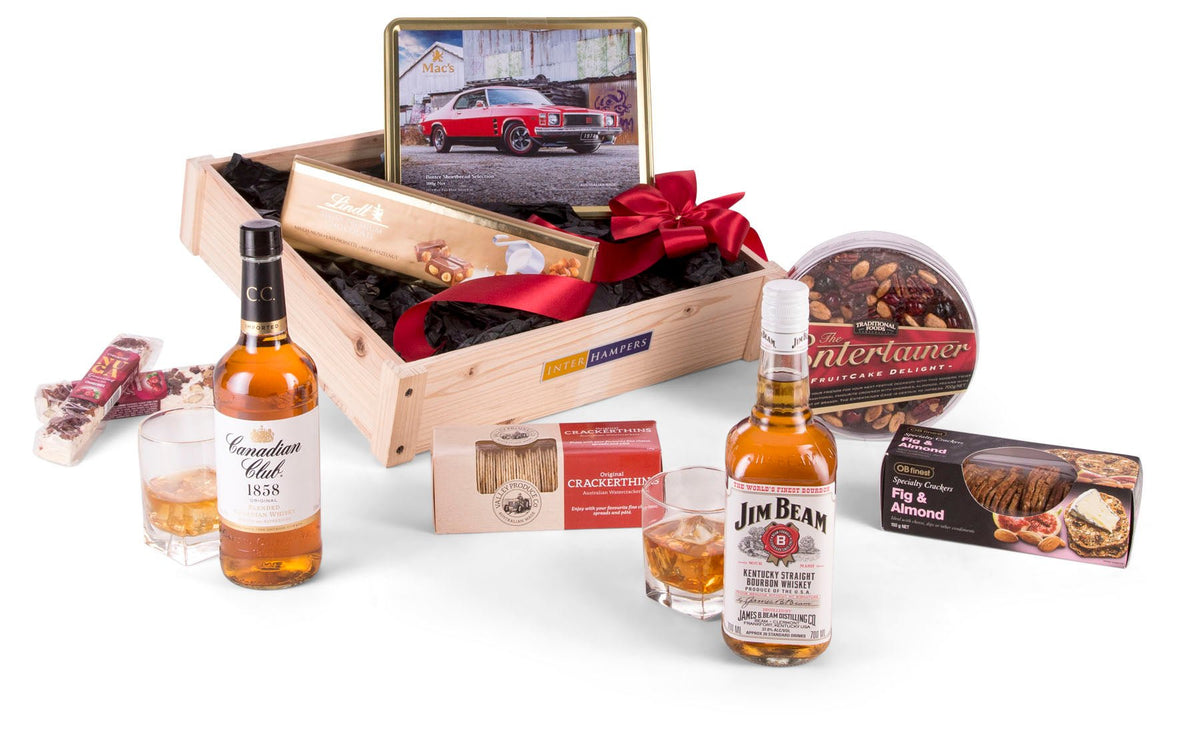 wooden crate with tin of shortbread inside and whiskey bottles and treats in front