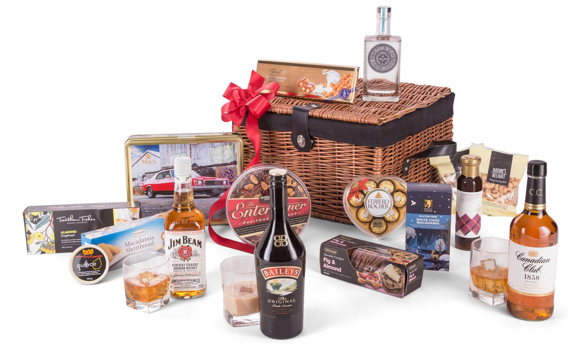 wicker chest with bottles of spirits and gourmet treats displayed in front