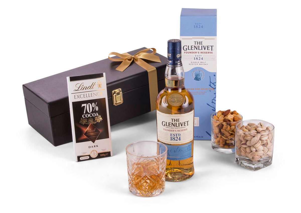 a bottle of Glenlivet Scotch Whisky with a measure in a glass in front of the gift box